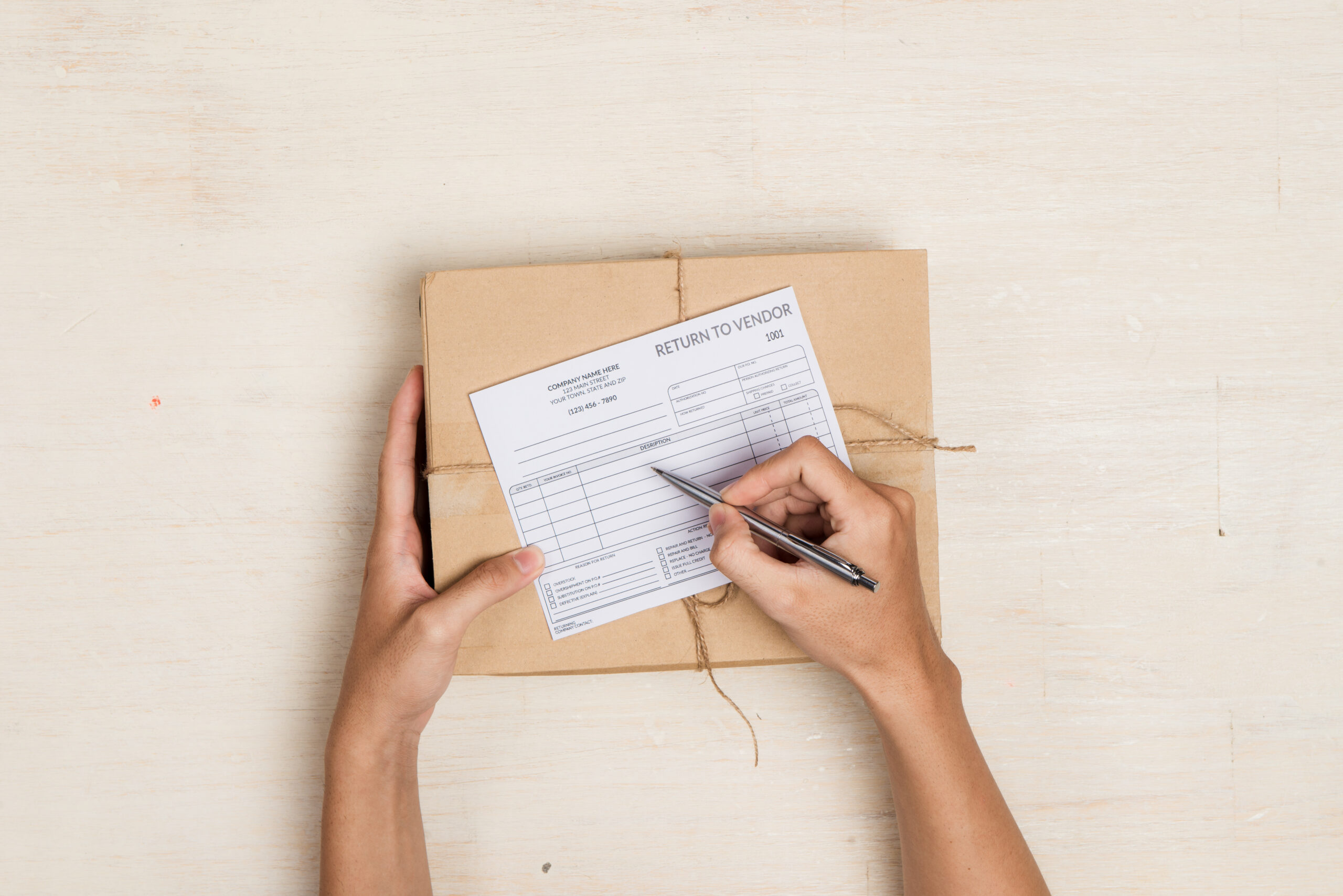 deliveryman making notes in "return to vendor" delivery