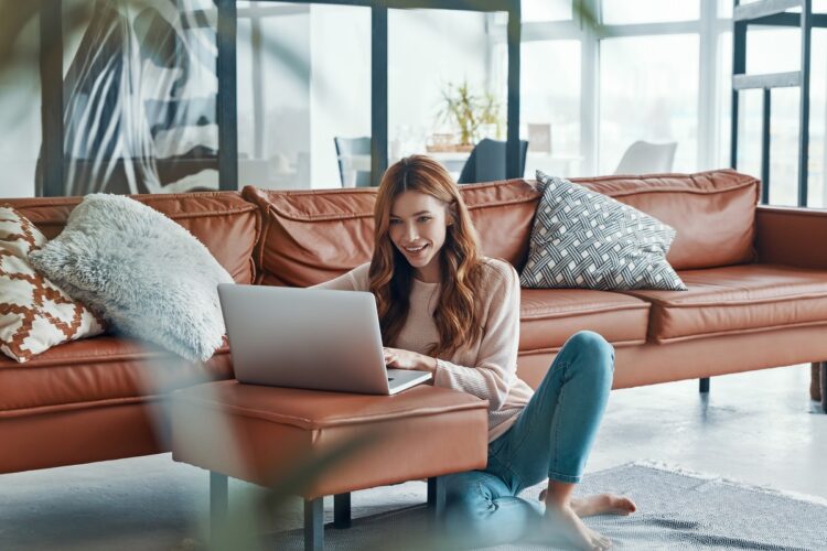 Beautiful young woman using laptop