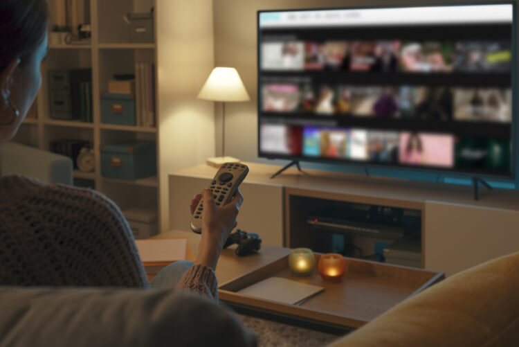 Woman watching TV at home and relaxing