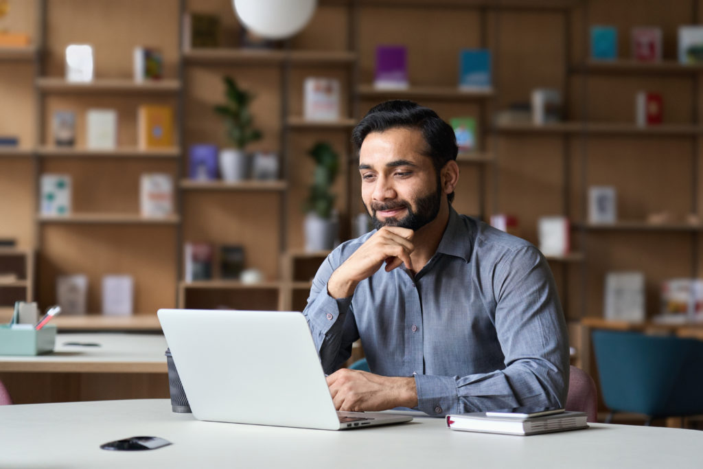 Smiling businessman working with his laptop.