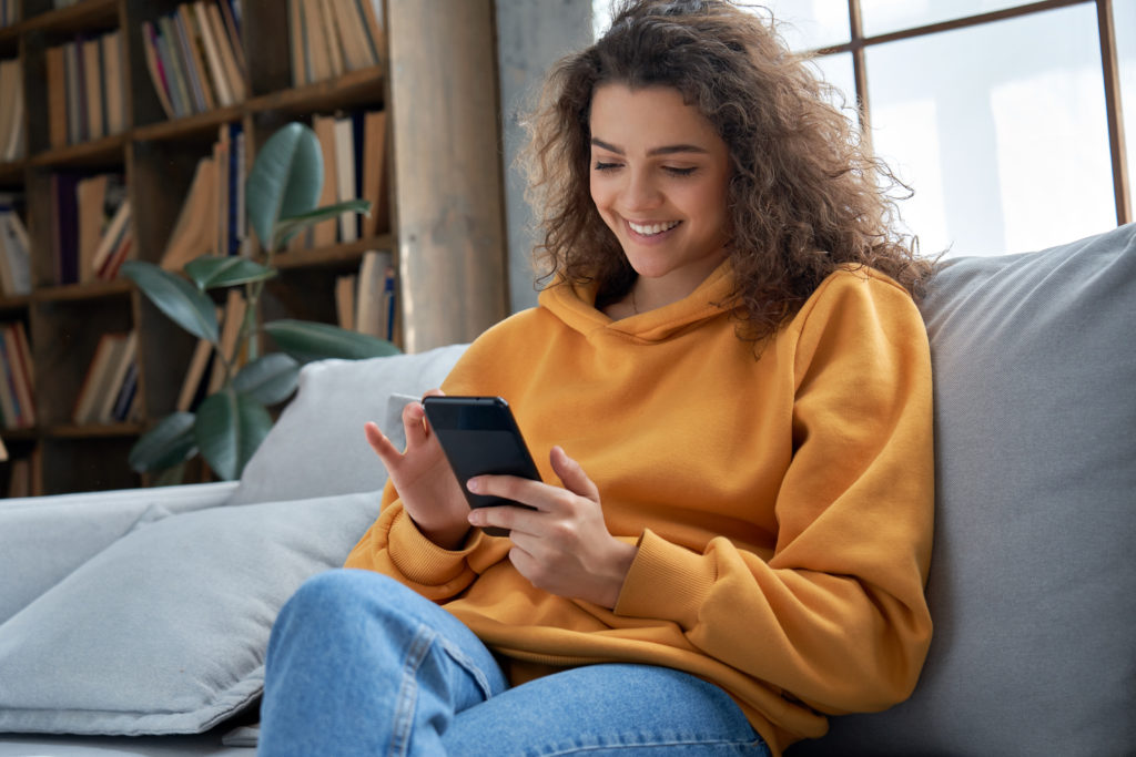 Smiling woman enjoying her phone.