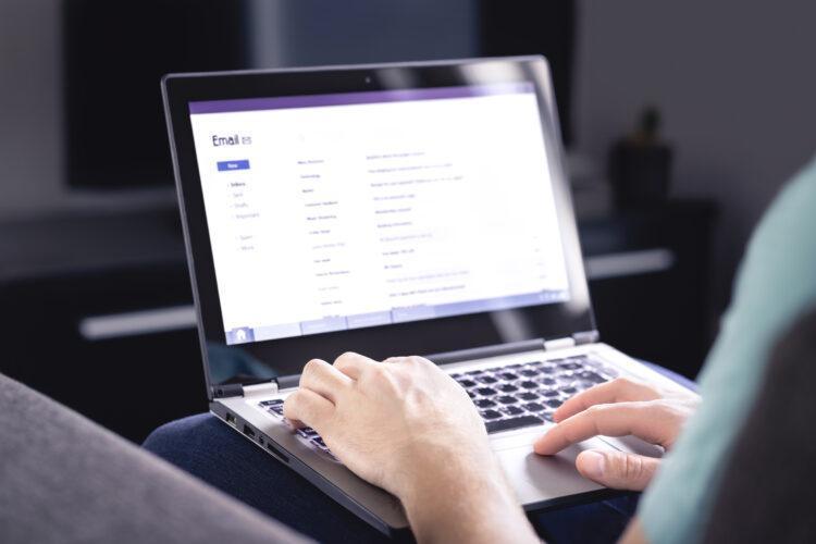 Man checking out his email inbox on laptop