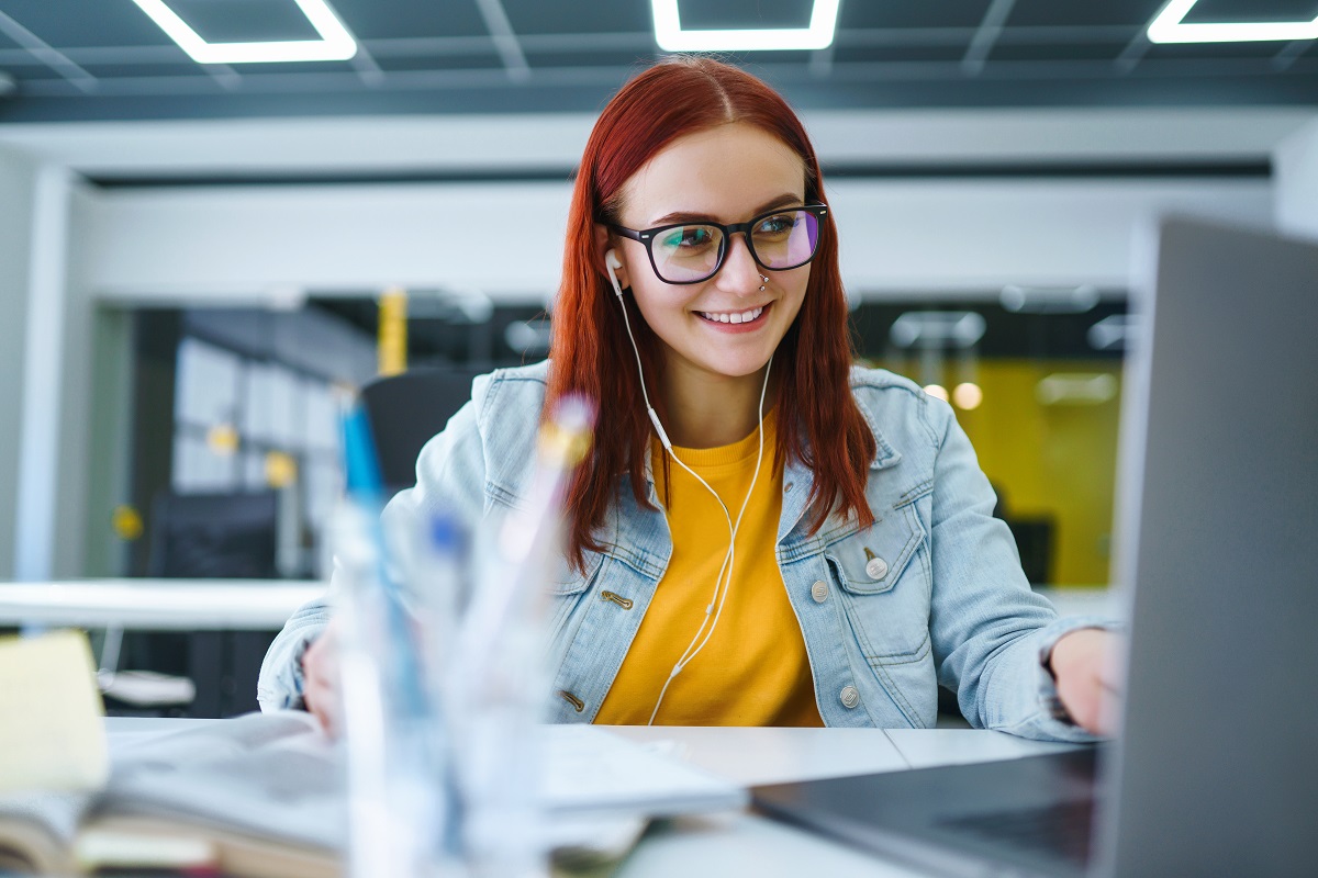 young woman works at a computer in the modern office