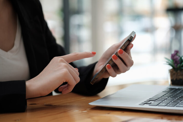 hand of woman using smart phone at cafe