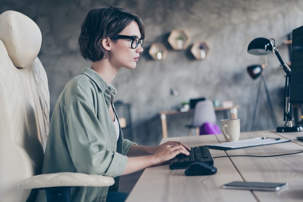 Female manager typing code html css cyber company at work place station indoors