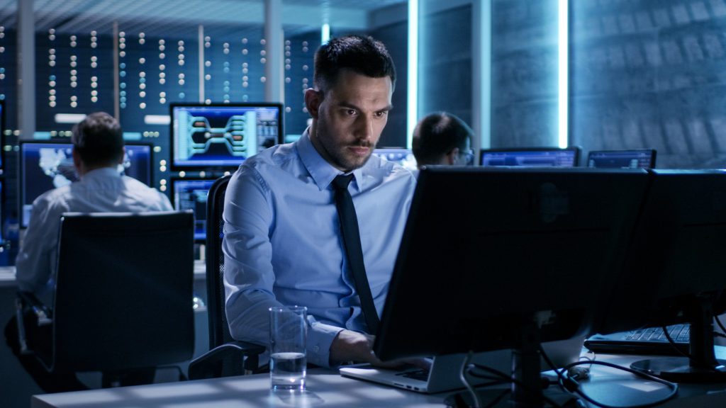 Technical engineer working in a monitoring room.