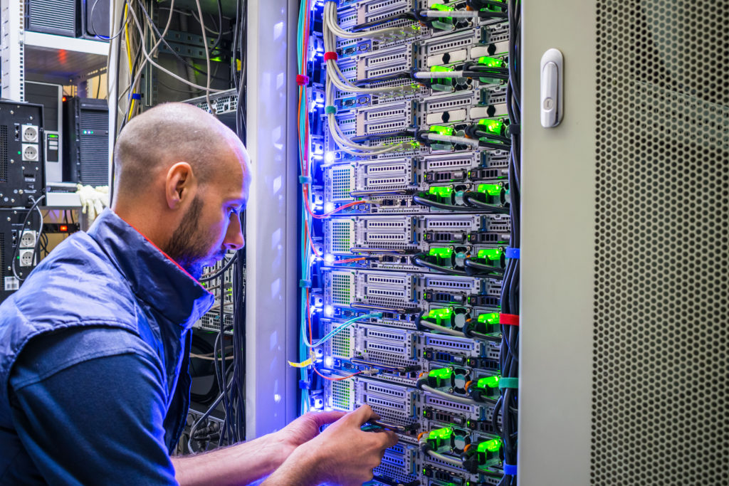 Technician fixing the internet server cables.