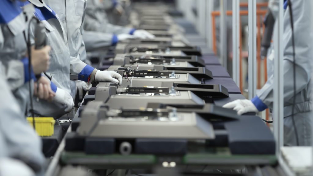 Line assembly of televisions at a factory.