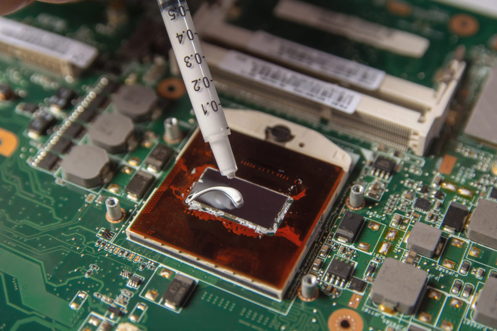 Applying thermal paste on the CPU processor.