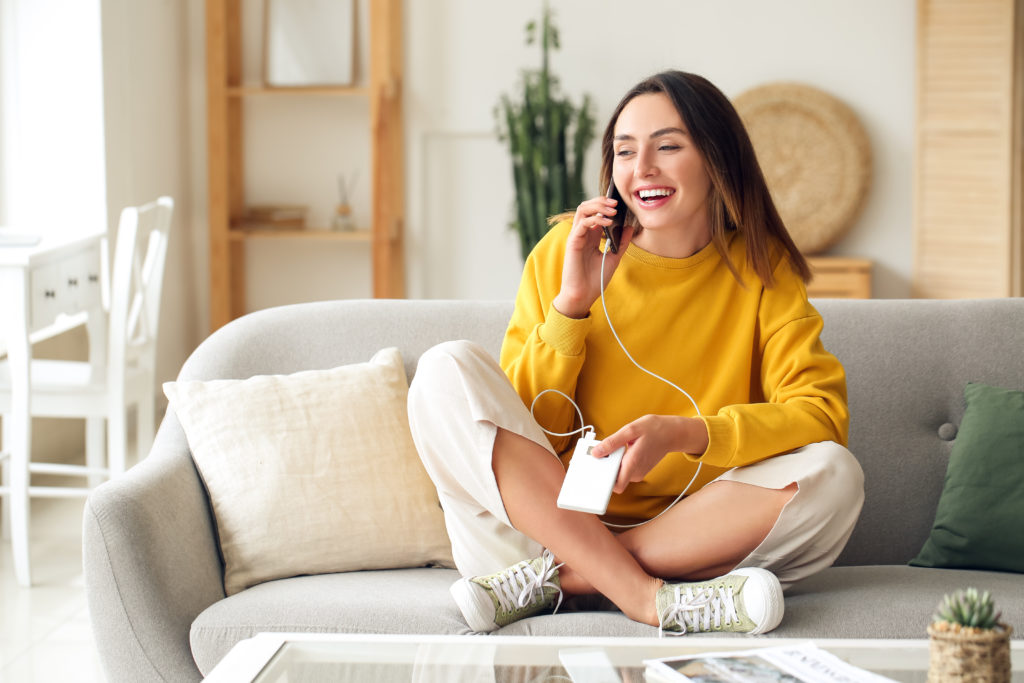 Young woman on the phone while charging.