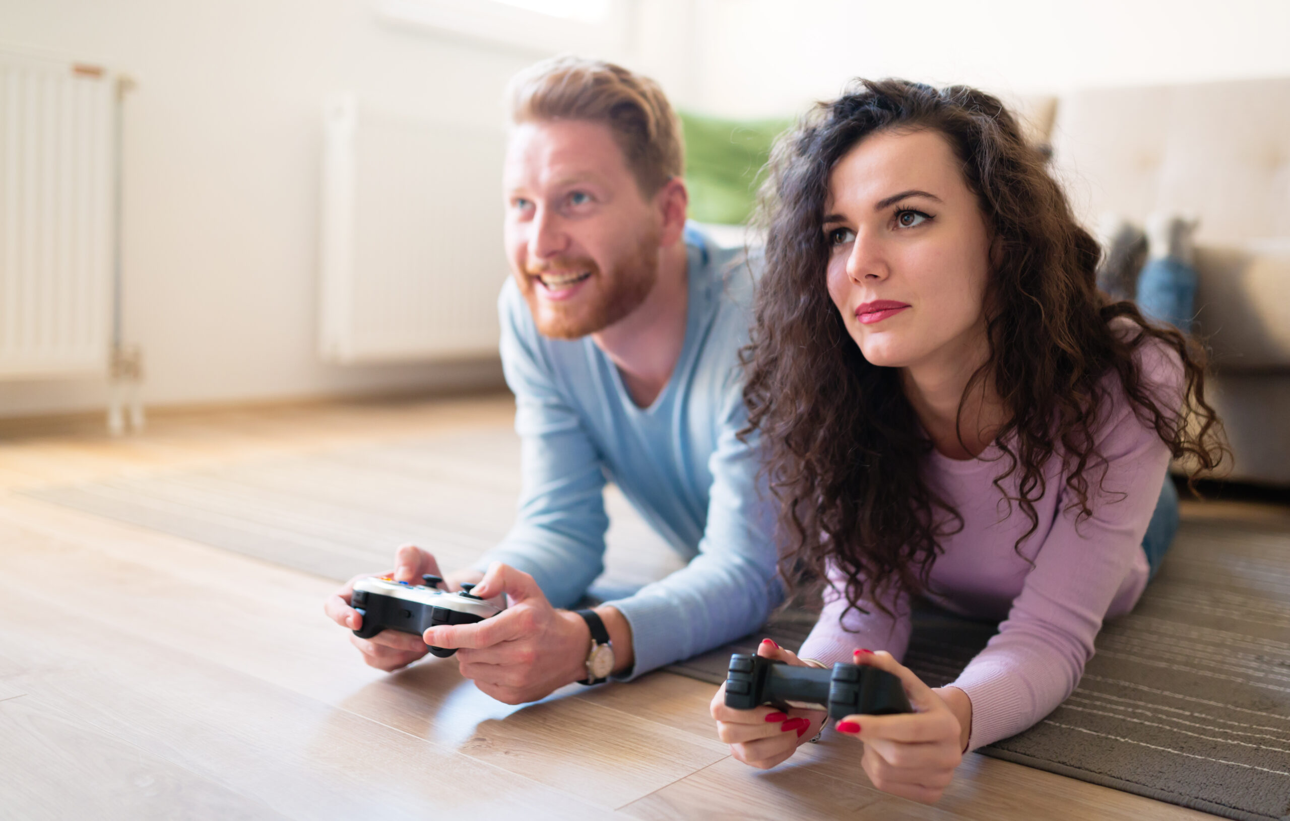 Beautiful couple playing video games on console