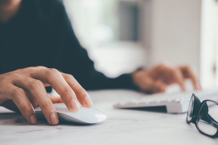 businessman using computer mouse with computer keyboard