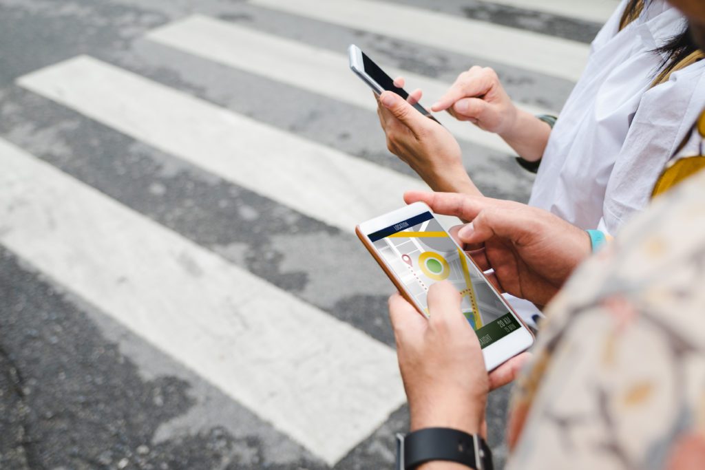 Travelers use map application on their mobile phones.