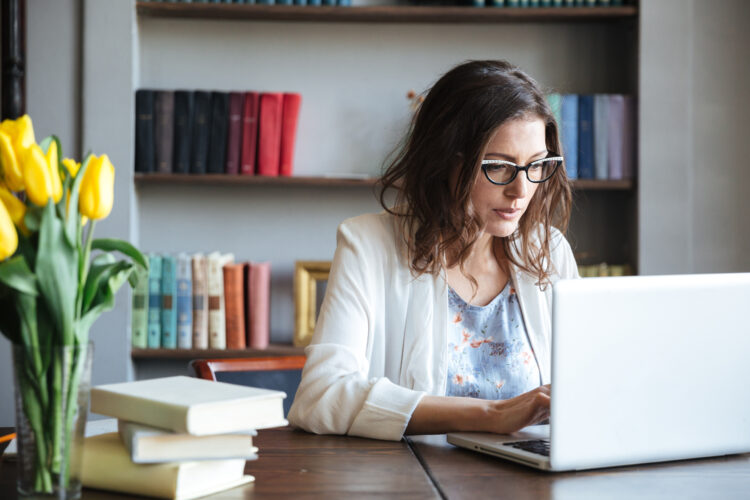 mature woman working intently on a laptop