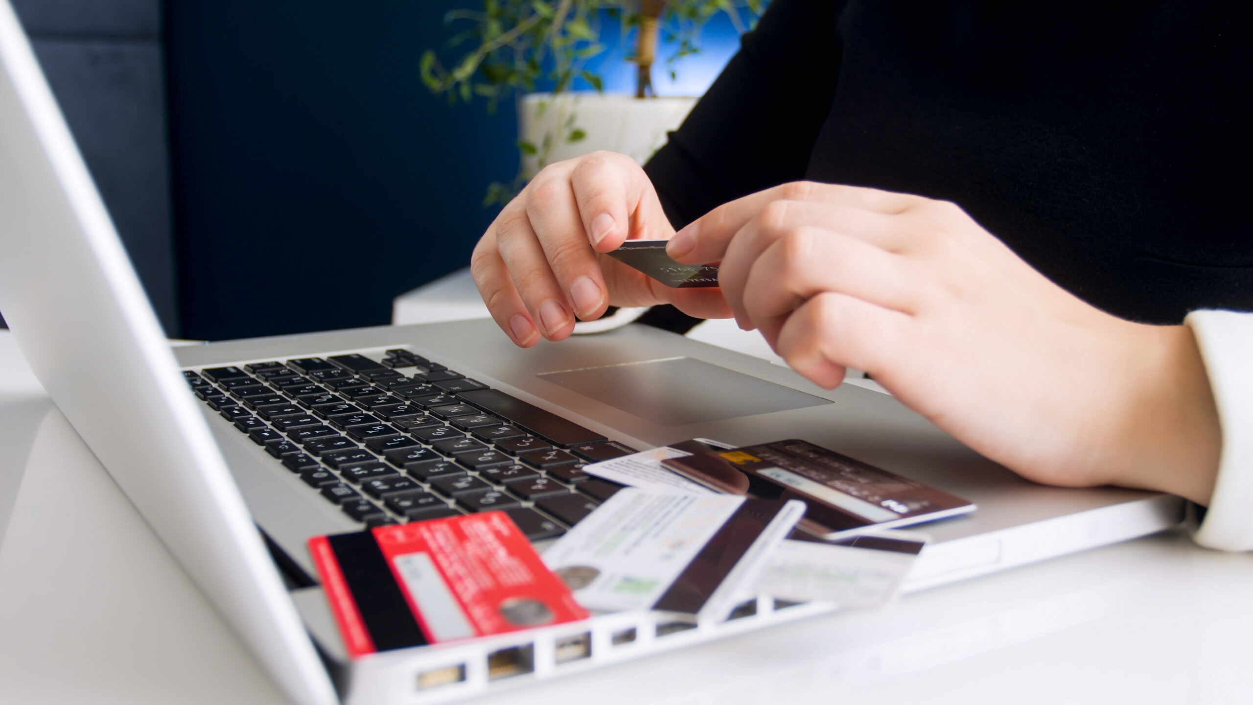 young woman using different credit cards to pay online