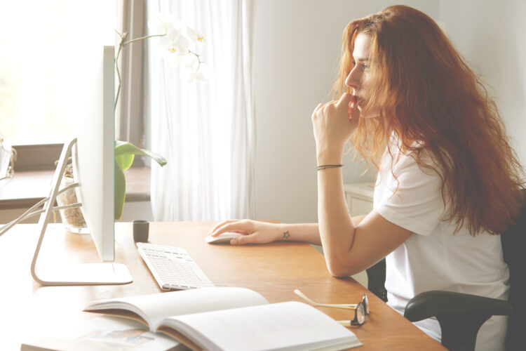 beautiful young female office worker sitting in front of the computer. 