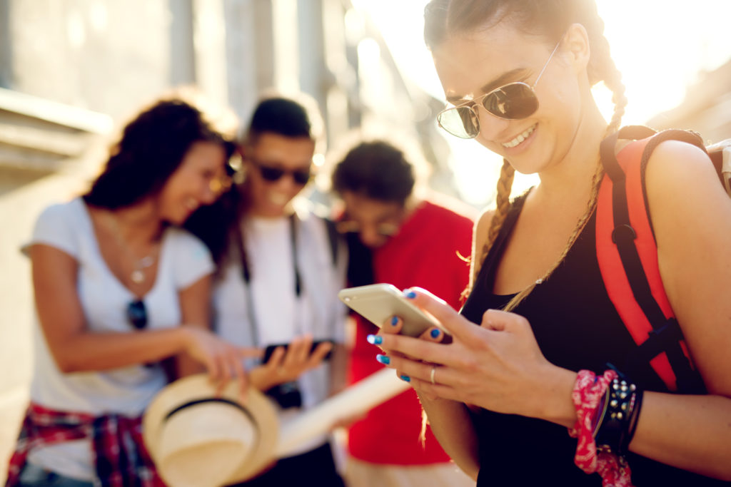 Young tourists searching for how to turn off location sharing on iphone.