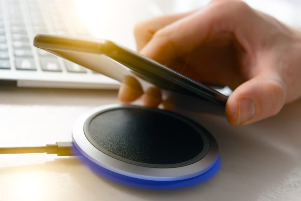 Smartphone charging on a wireless charger.