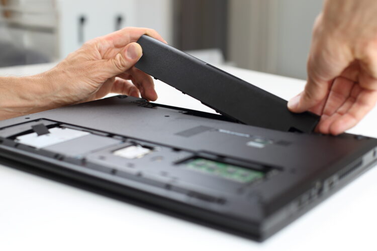 man removing laptop battery