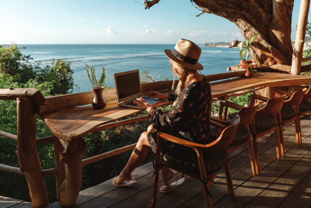 Woman working on her laptop at an outdoor café