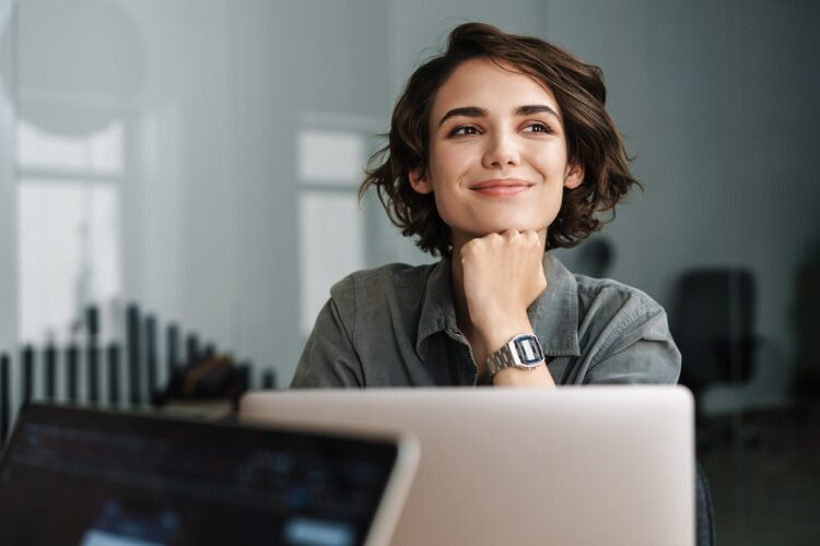 beautiful joyful woman smiling while working in the office