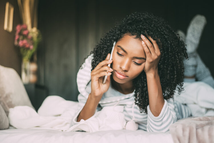 Beautiful thoughtful and sad young woman with curly hair