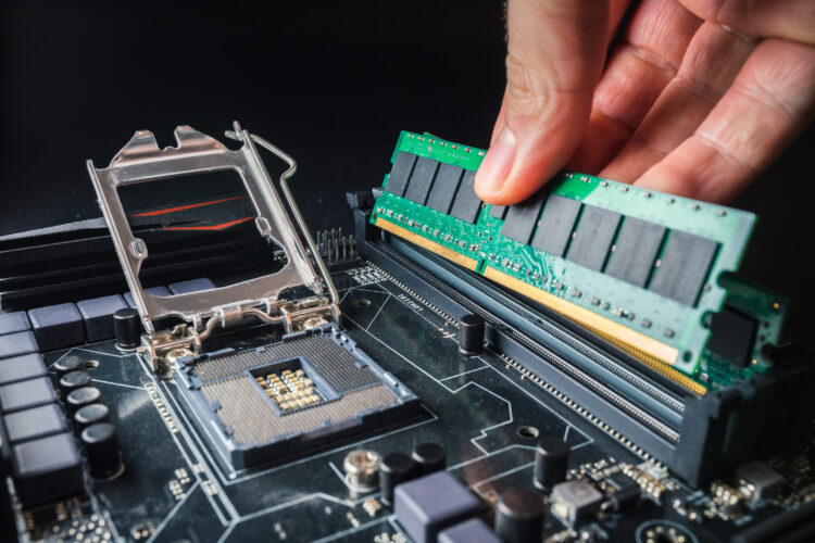 Installing a new RAM DDR memory for a personal computer processor socket in a service. 
