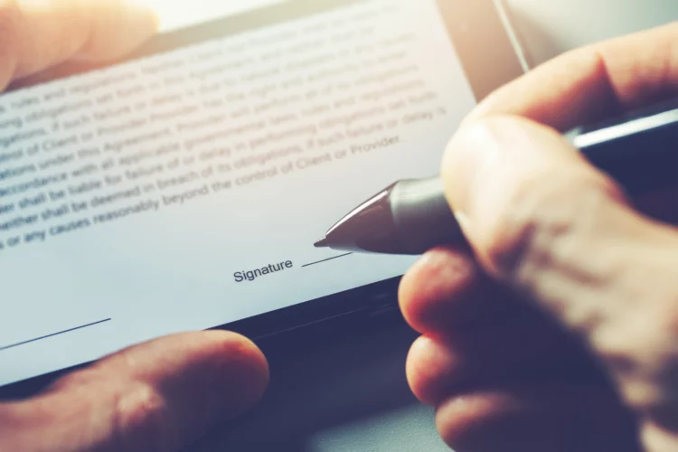 electronic signature, man signs distance contract with digital pen on mobile phone