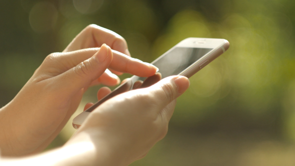 Girl on phone to check the battery and phone's temperature.