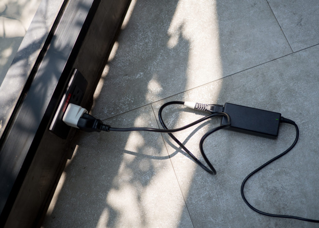 Laptop charger plugged into a power socket.