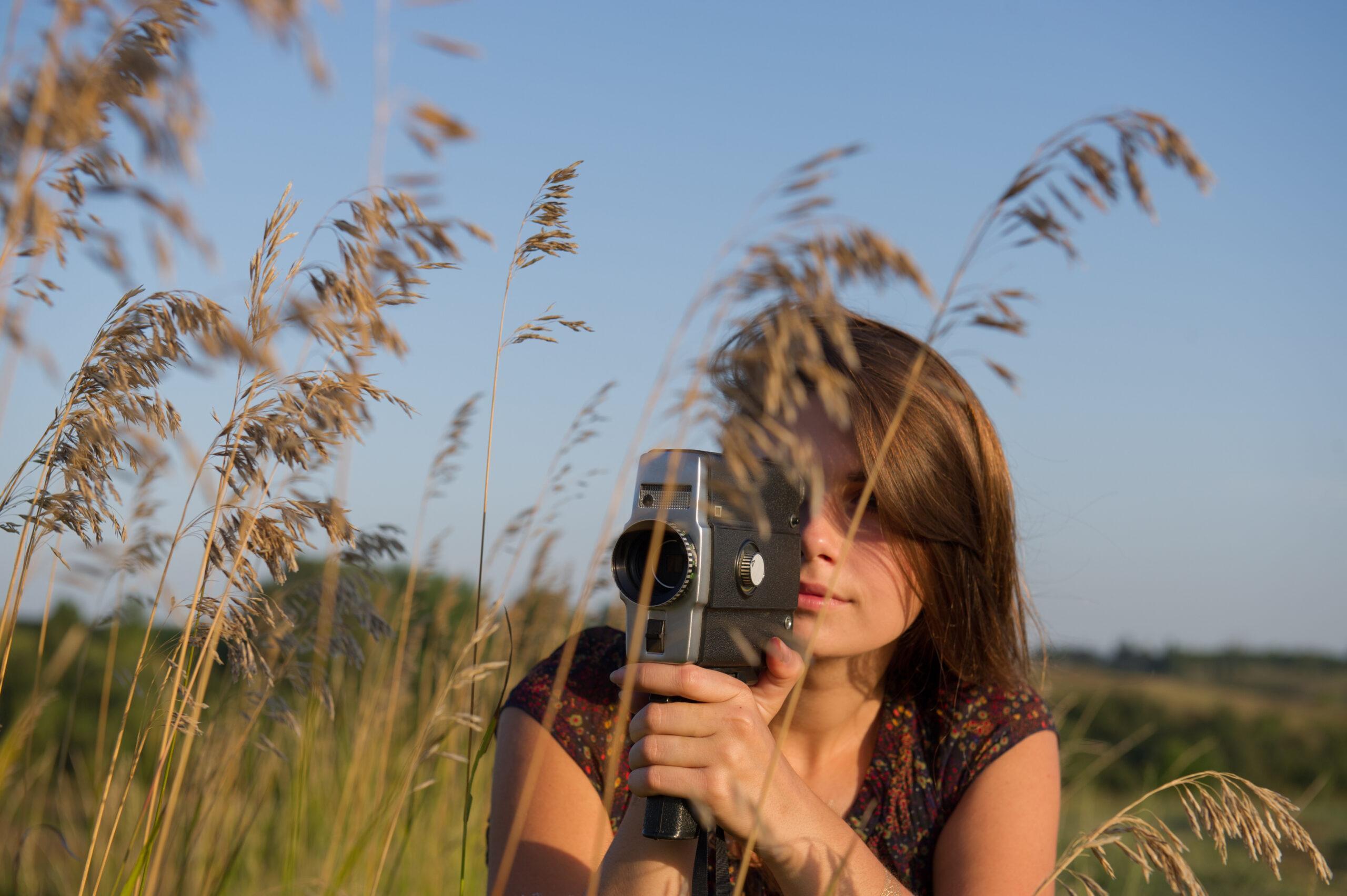 Girl shoots a movie camera