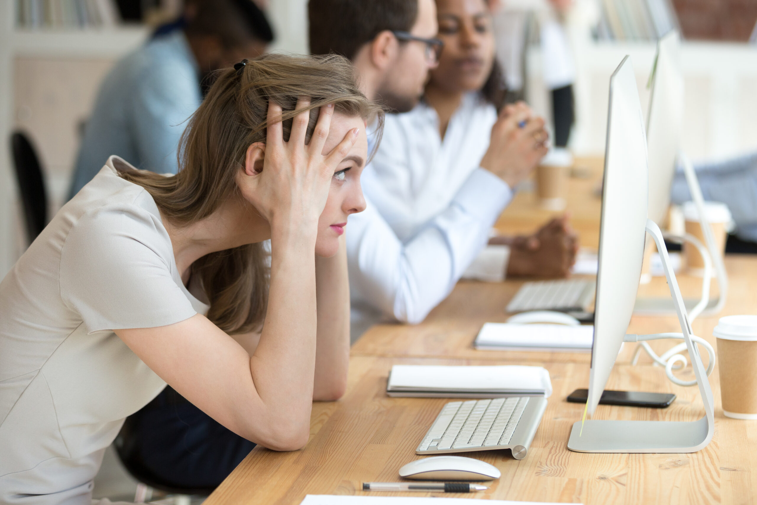 Stressed female employee having computer problem at work