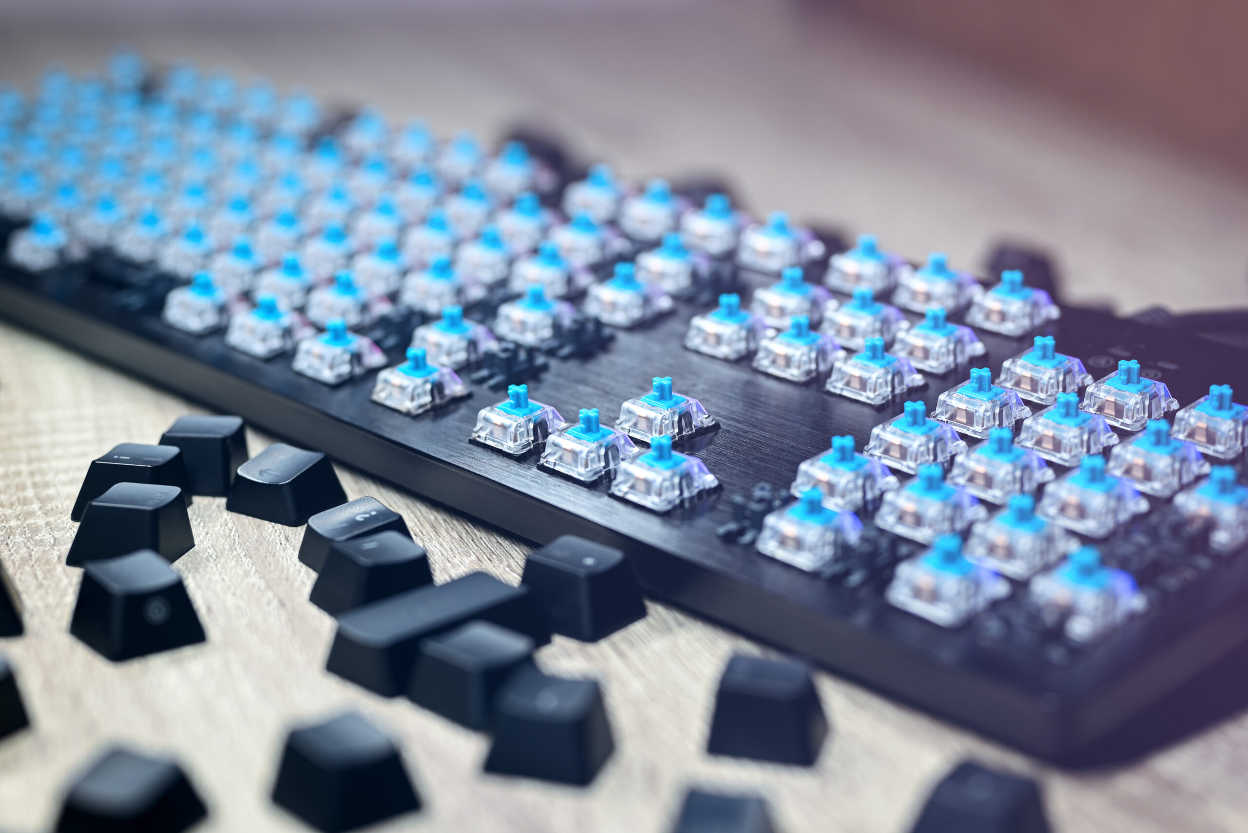 Disassembled black gaming mechanical keyboard. The keycaps are