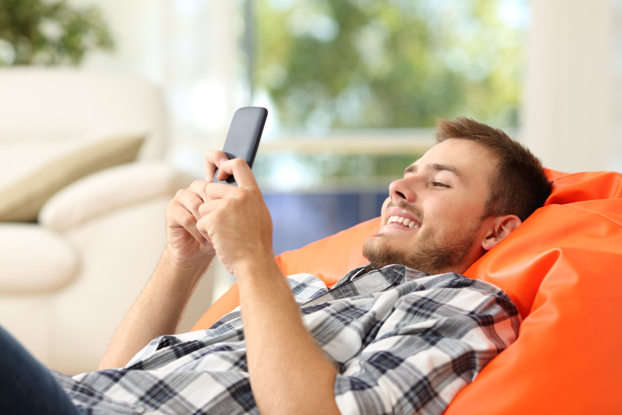 Relaxed man using a smart phone