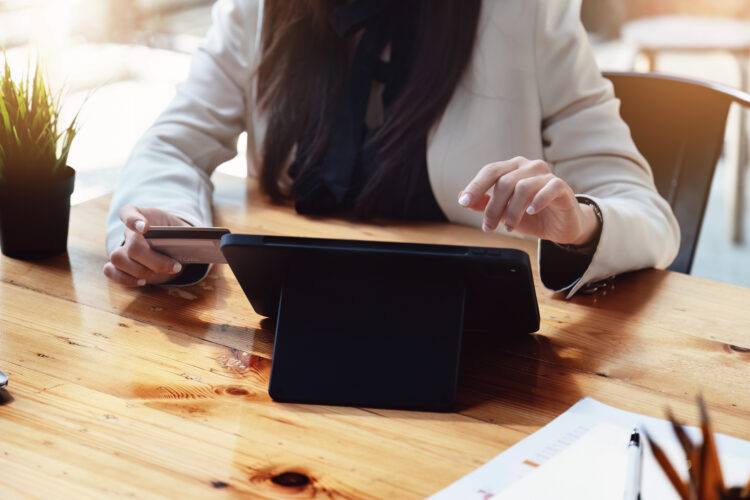 Asian young woman using a tablet and credit card for online shopping