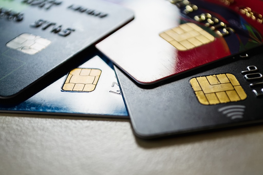 Few plastic credit cards with chips and contactless pay technology.