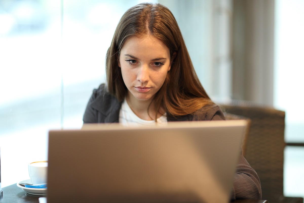 focused woman looking at laptop