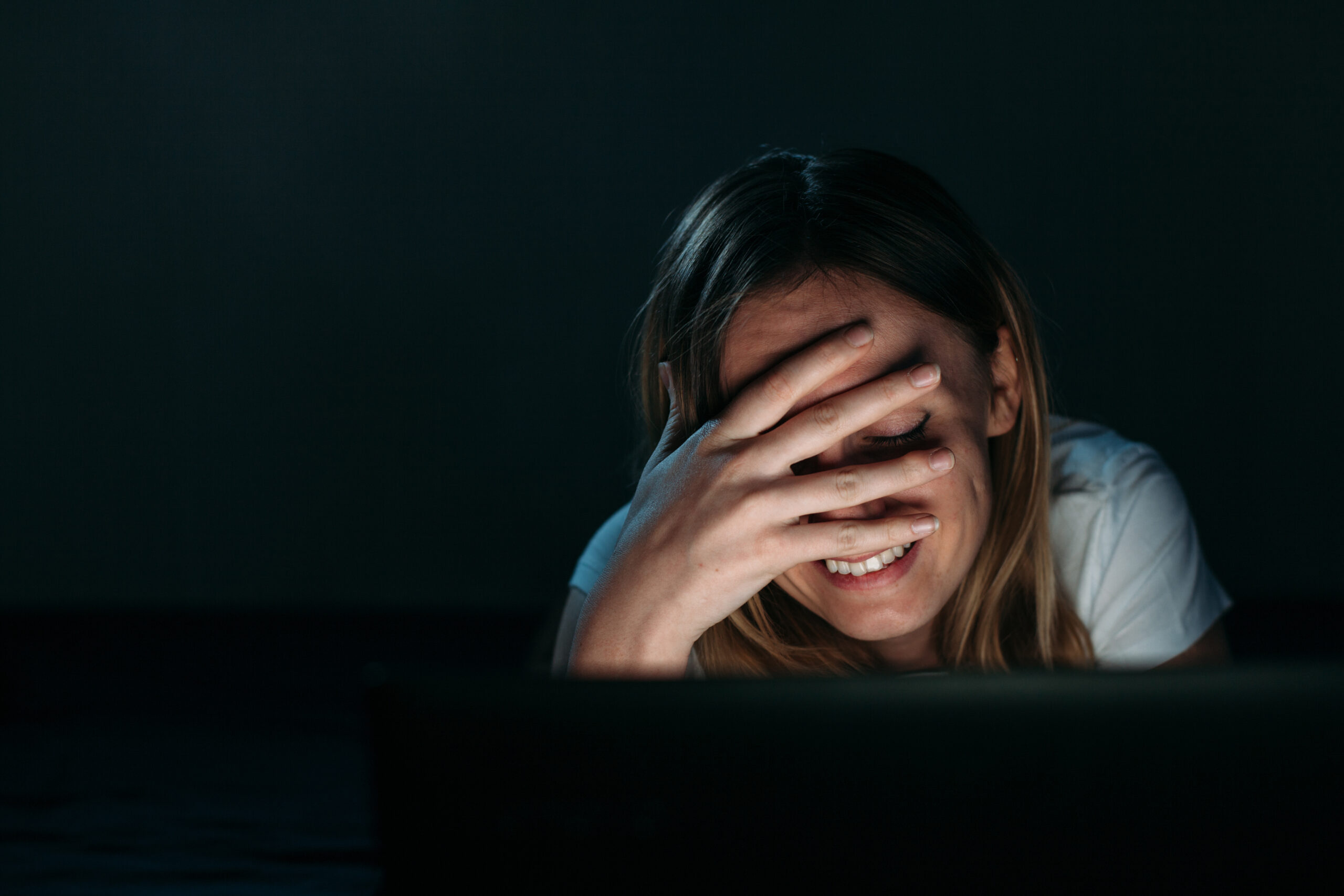 A cute woman facepalm looking at the laptop