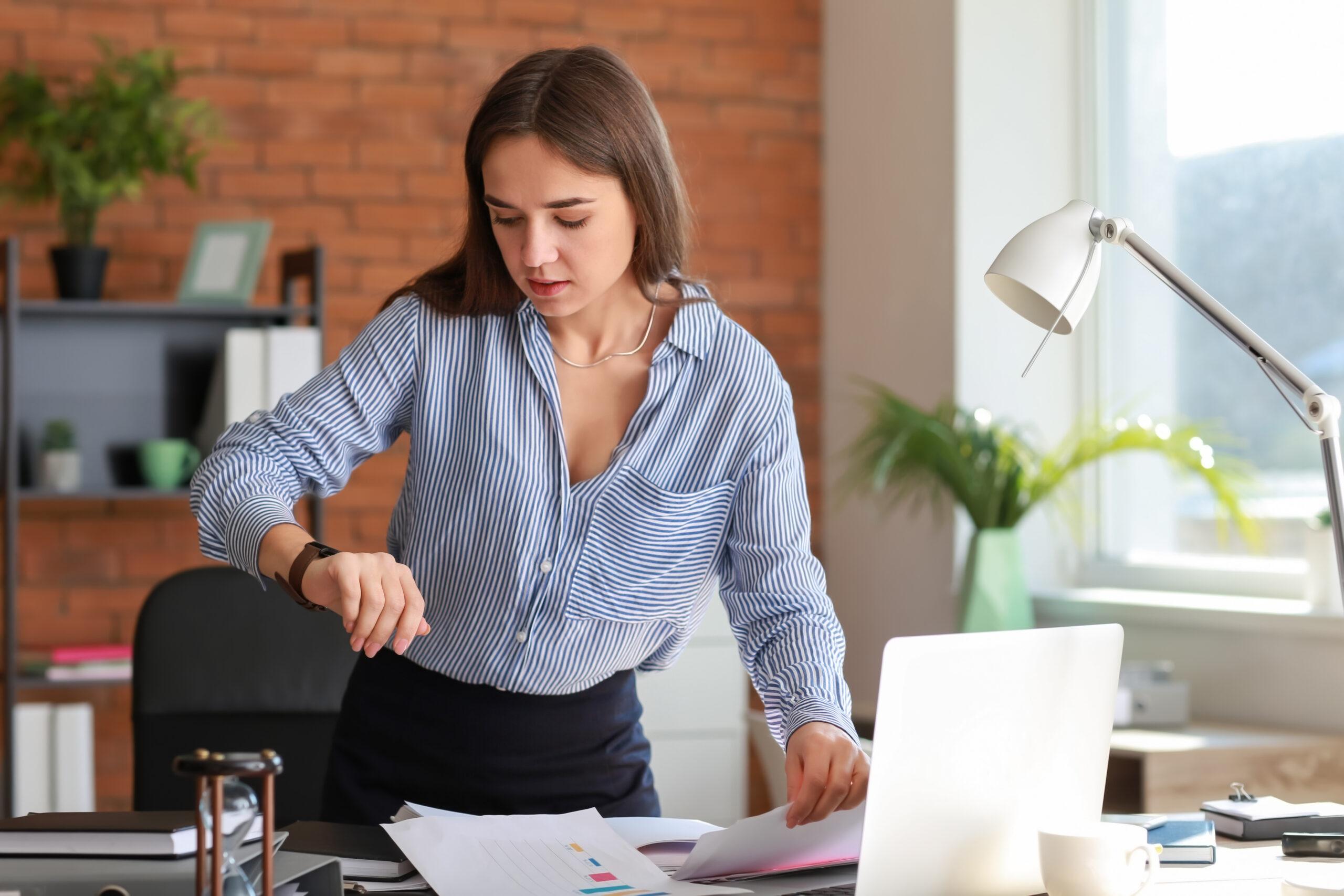 Stressed businesswoman trying to meet deadline in office