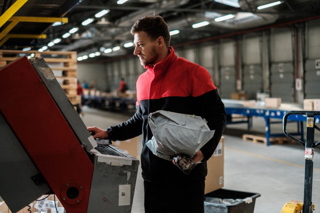 Courier picks up package on a warehouse