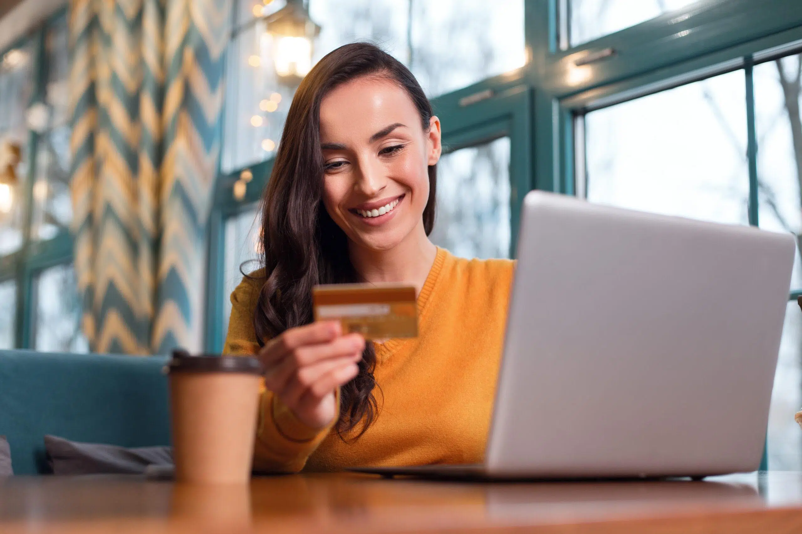 Gorgeous attractive woman paying with credit card