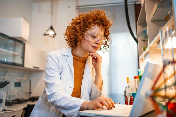 Redhead confident female scientist working in lab