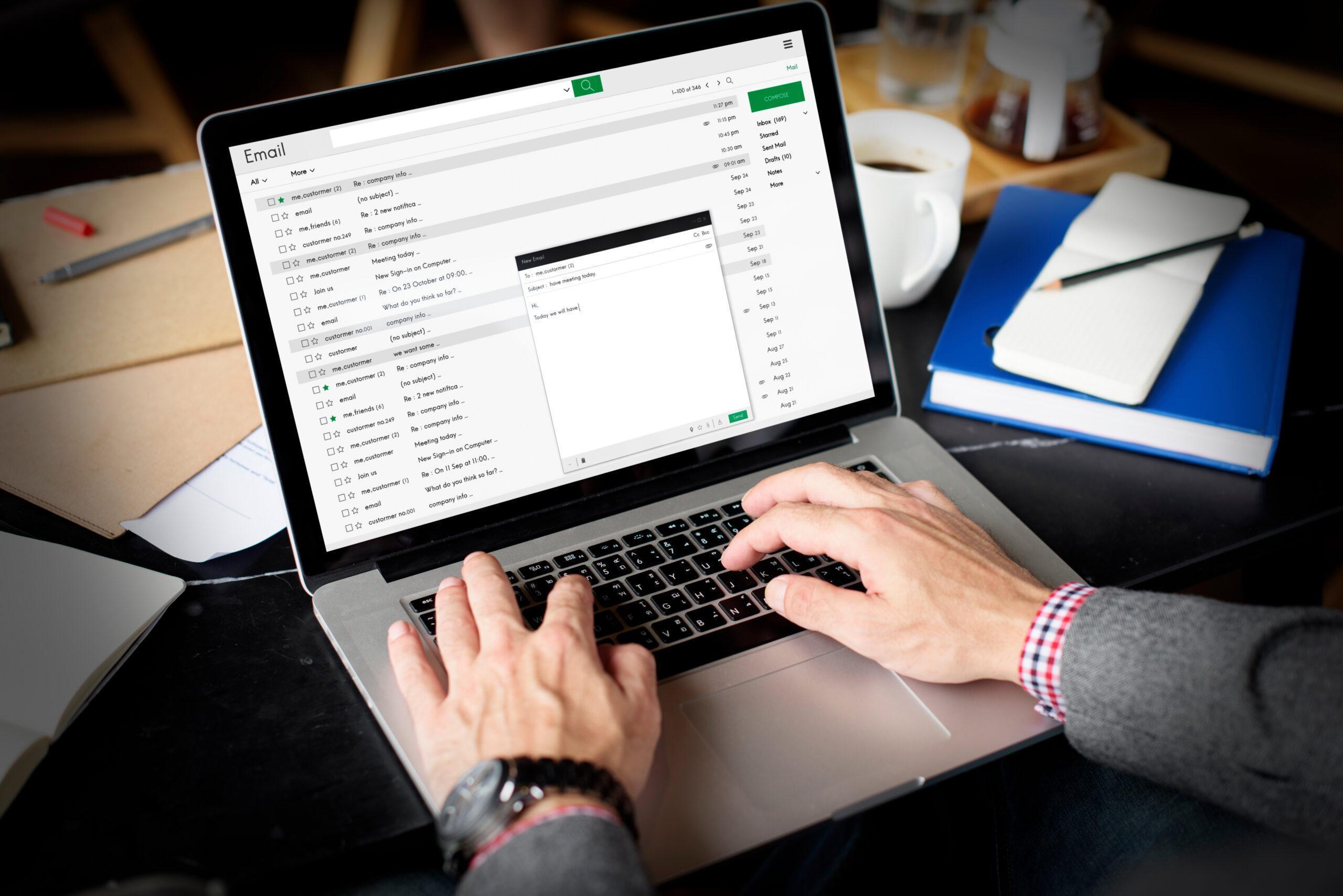 Man (only hands visible) typing responses to messages received in his inbox