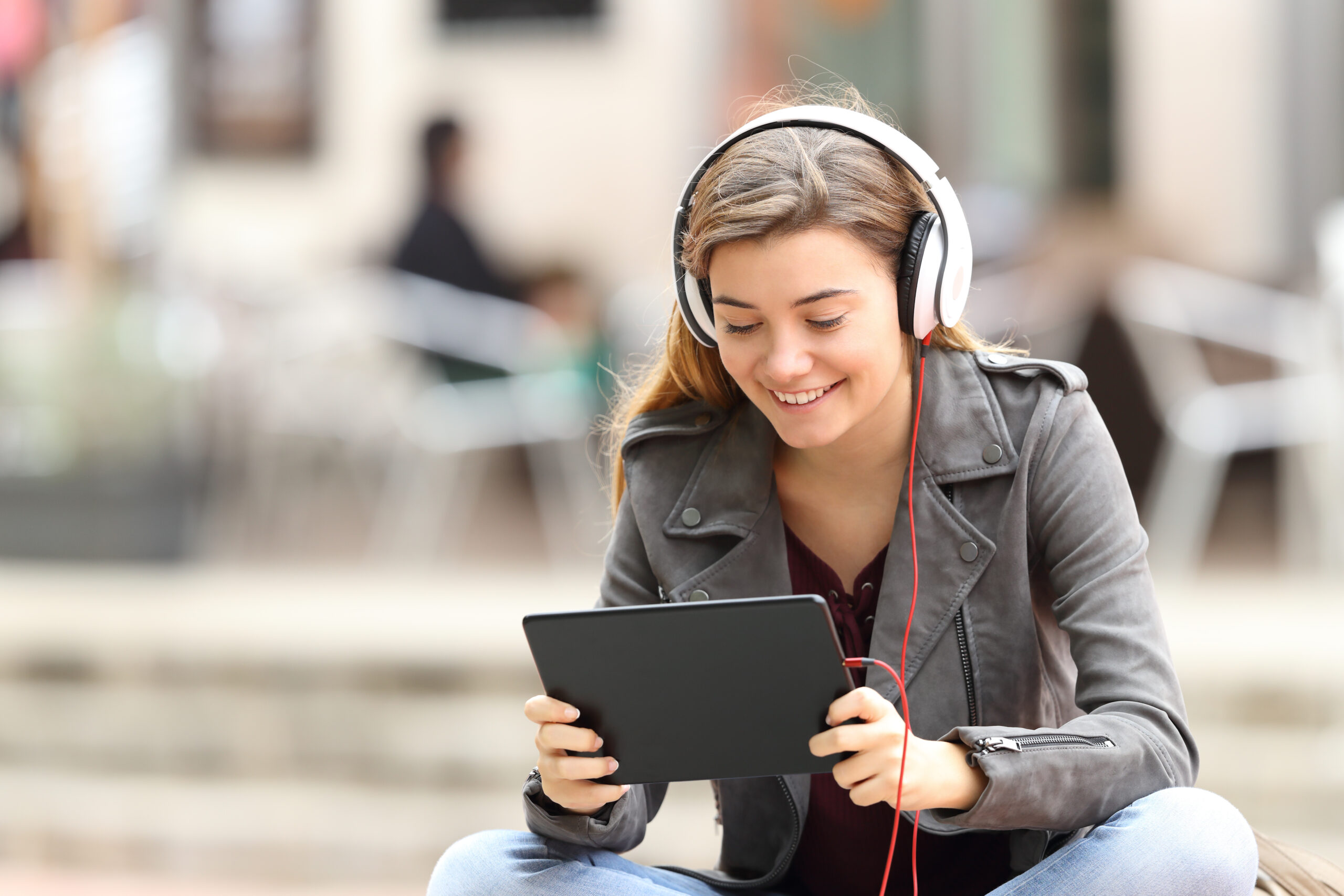 Girl with a tablet and headphones