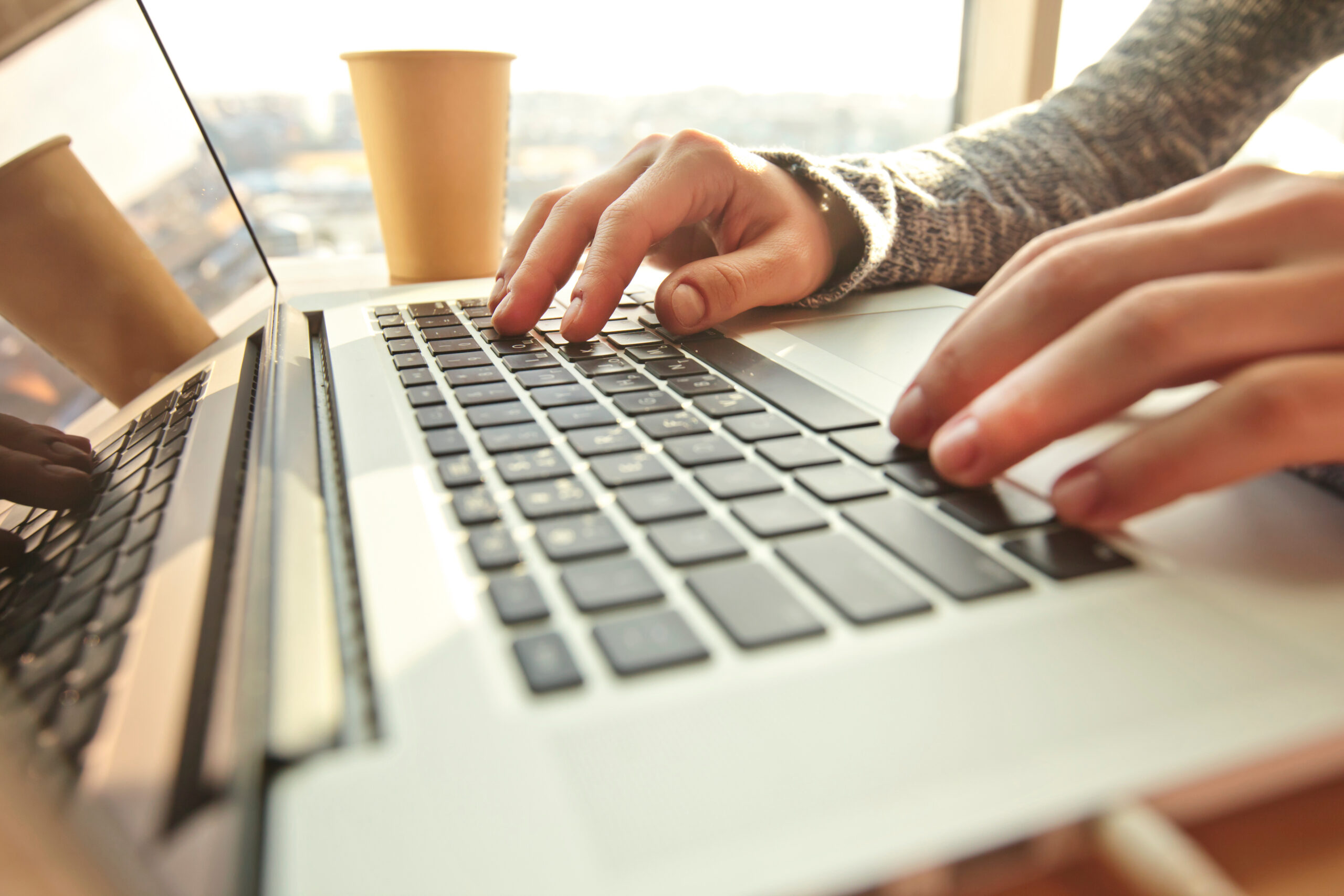 Young woman working at the modern laptop