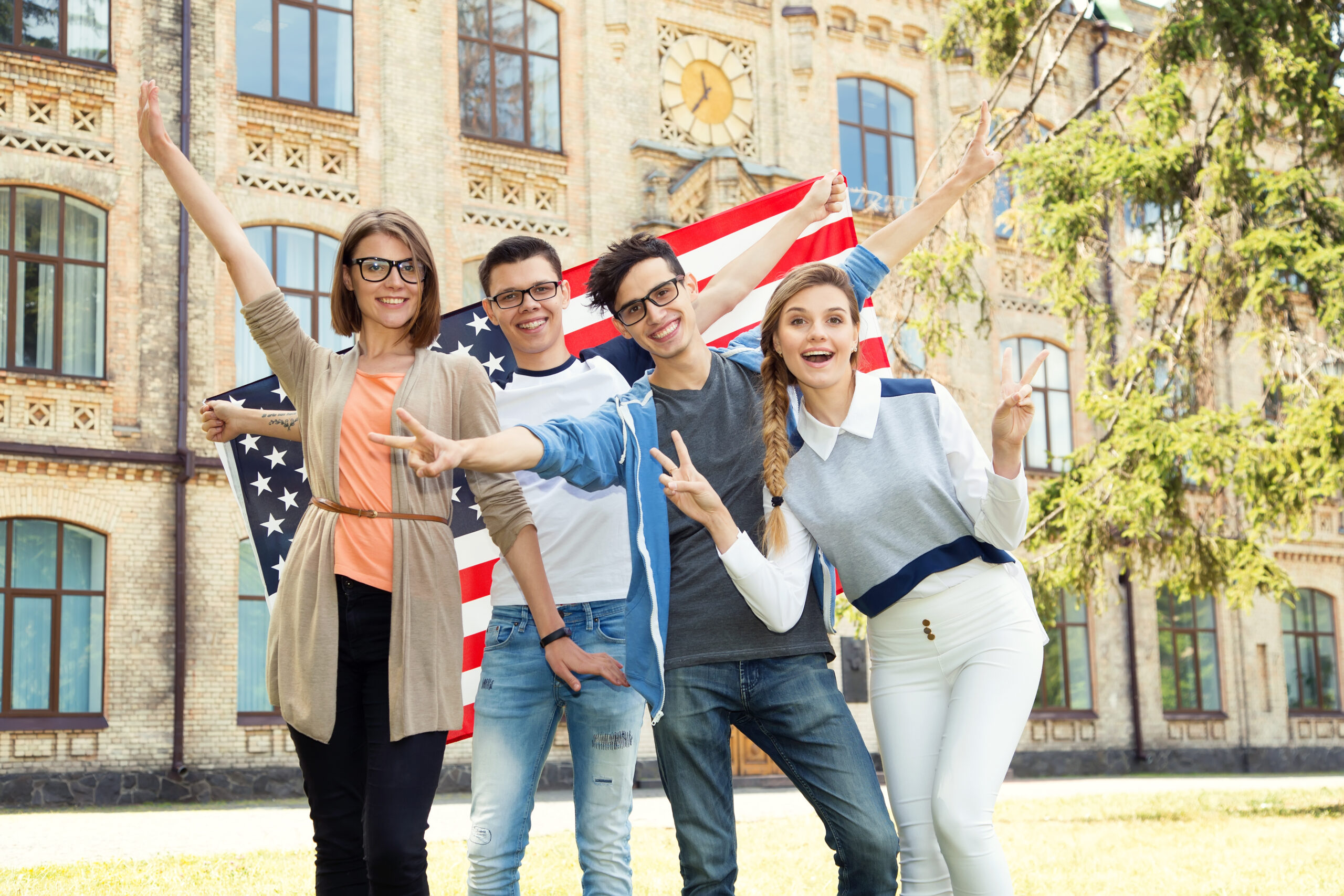 Group of students holding flag of USA on the university campus