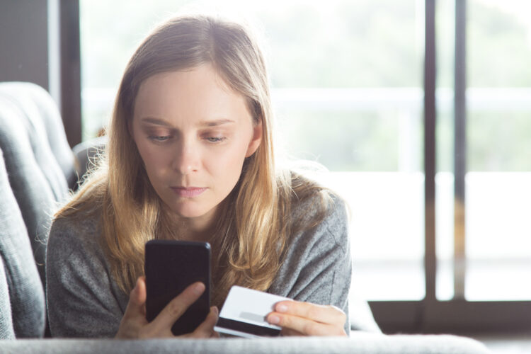 Serious woman buying online