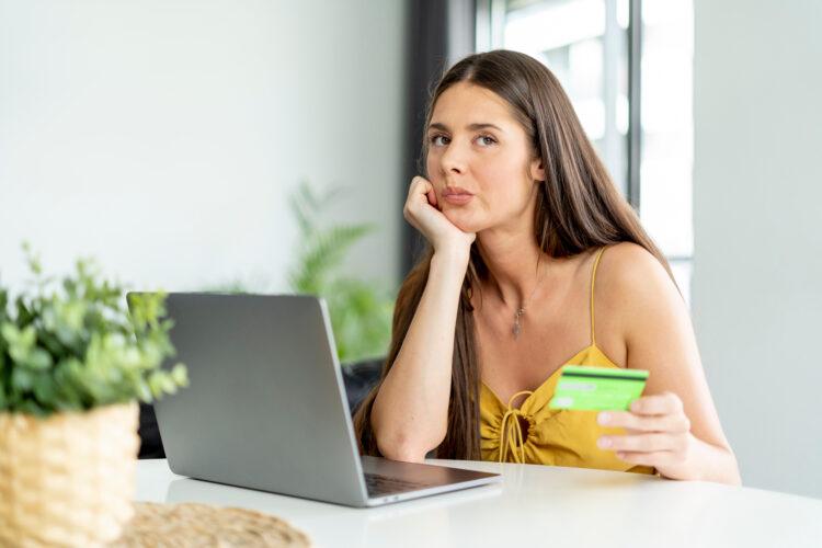 Woman with frustrated expression doing online shopping