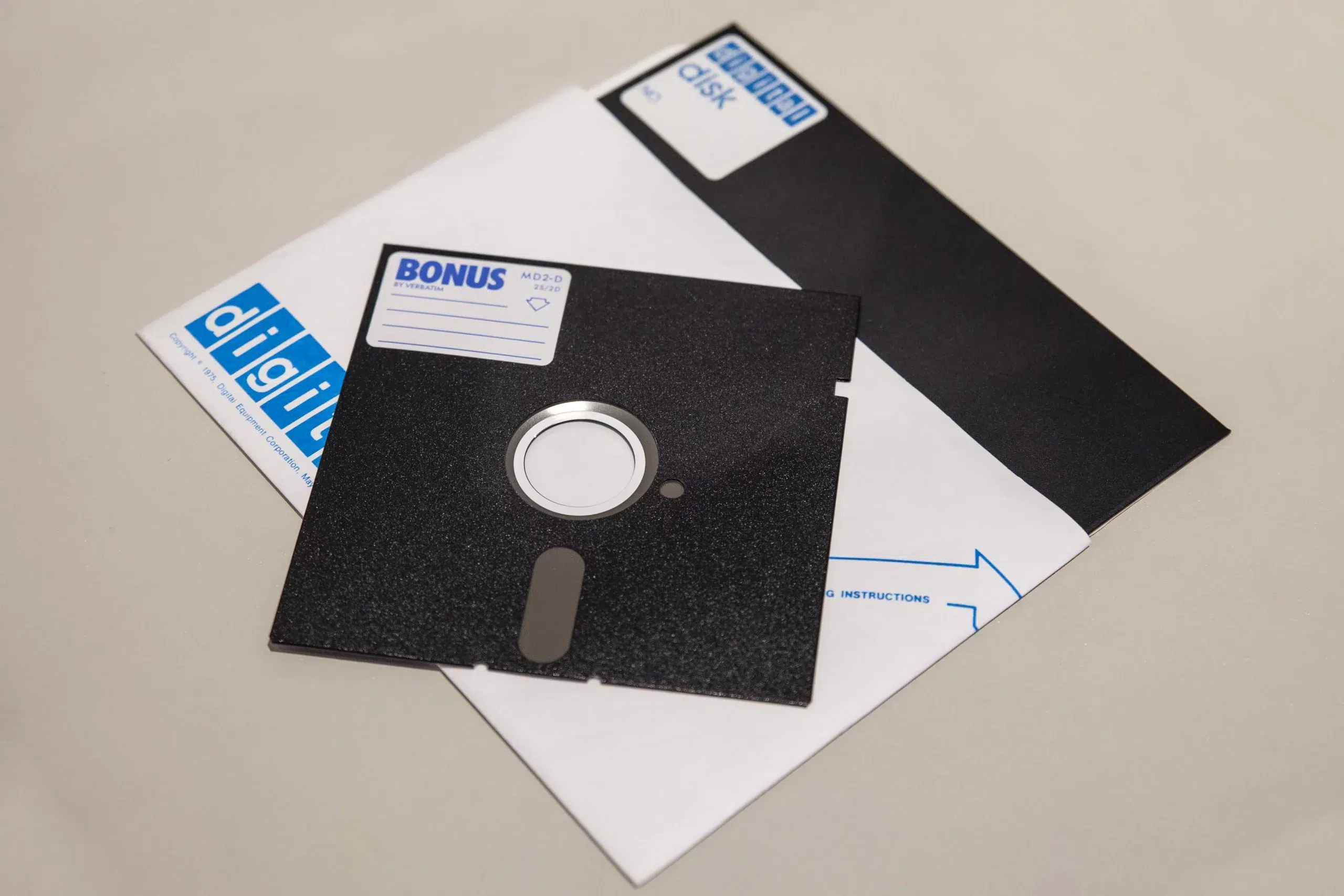 Floppy disk on top of another floppy disk inside its packet