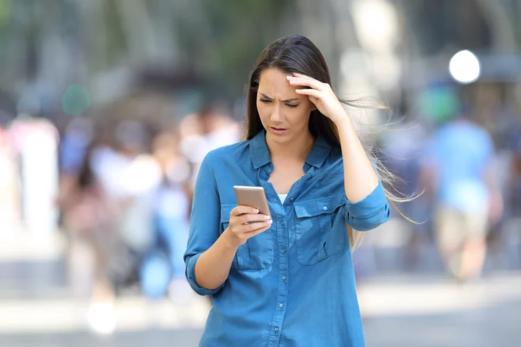 anxious woman checking smart phone